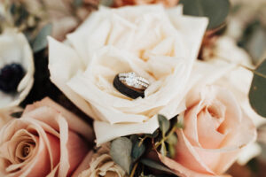 Diamond Engagement Ring with Double Band on Top of White Rose Bouquet