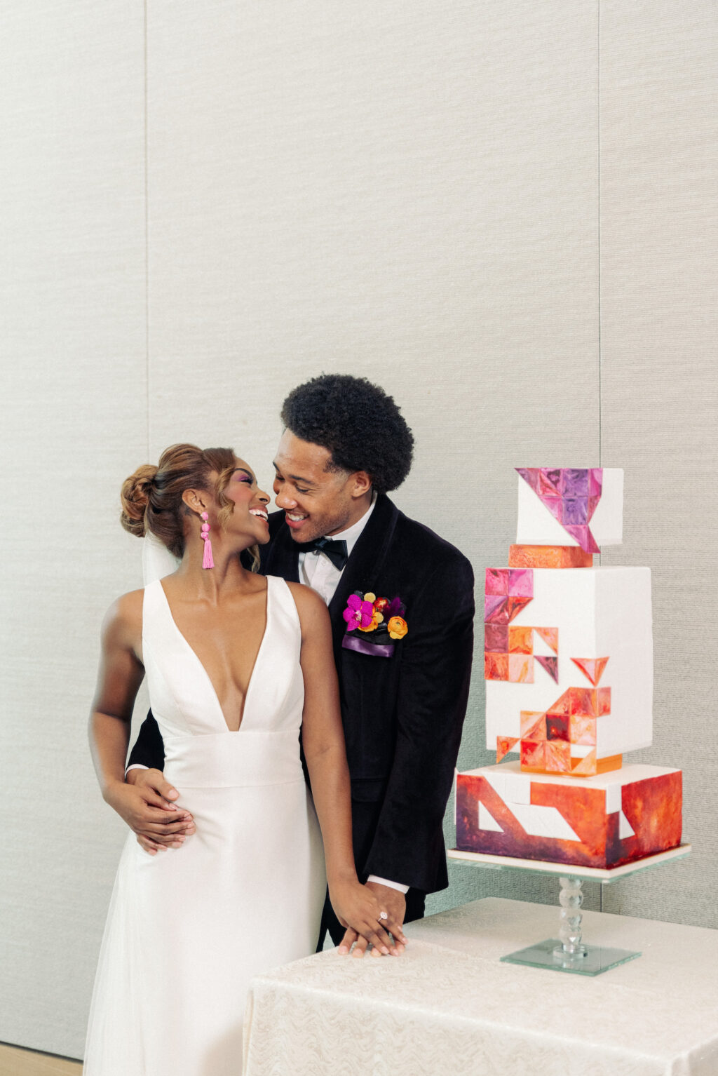 Modern Bride and Groom Standing with Unique Whimsical Geometric Three Tier Wedding Cake, Red, Purple, and Orange Swirled Painted Shapes | Tampa Bay Wedding Photographer Dewitt for Love | Wedding Cake The Artistic Whisk
