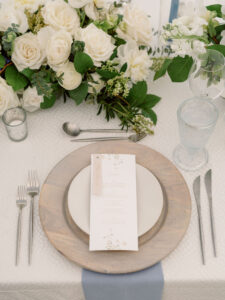 Elegant Florida Wedding Reception Decor and Details, Natural Wood Element Circle Charger, Neutral Table Linen, Ivory and White Florals with Greenery, Dusty Blue Napkins