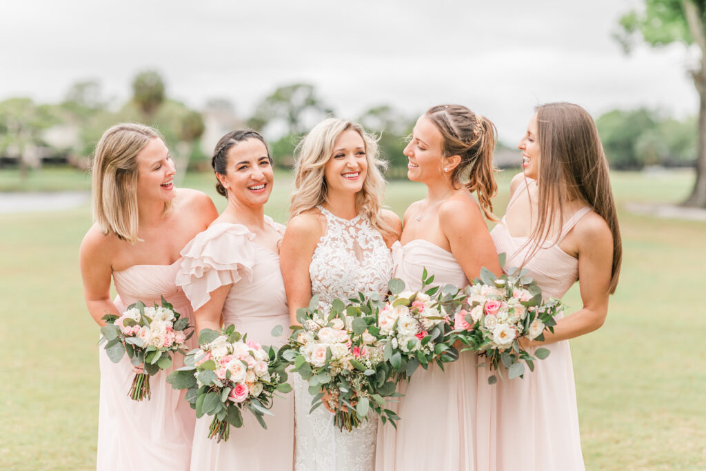 Romantic Pink St. Pete Garden Wedding | Bride Wearing Halter Lace Applique and Illusion Wedding Dress, Bridesmaids in Blush Pink Mix and Match Dresses Holding Ivory and Pink with Eucalyptus Greenery Floral Bouquets | Tampa Bay Wedding Florist Brides N Blooms Designs