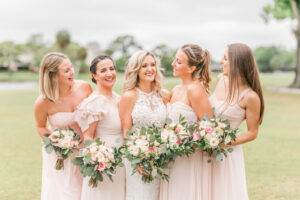Romantic Pink St. Pete Garden Wedding | Bride Wearing Halter Lace Applique and Illusion Wedding Dress, Bridesmaids in Blush Pink Mix and Match Dresses Holding Ivory and Pink with Eucalyptus Greenery Floral Bouquets | Tampa Bay Wedding Florist Brides N Blooms Designs