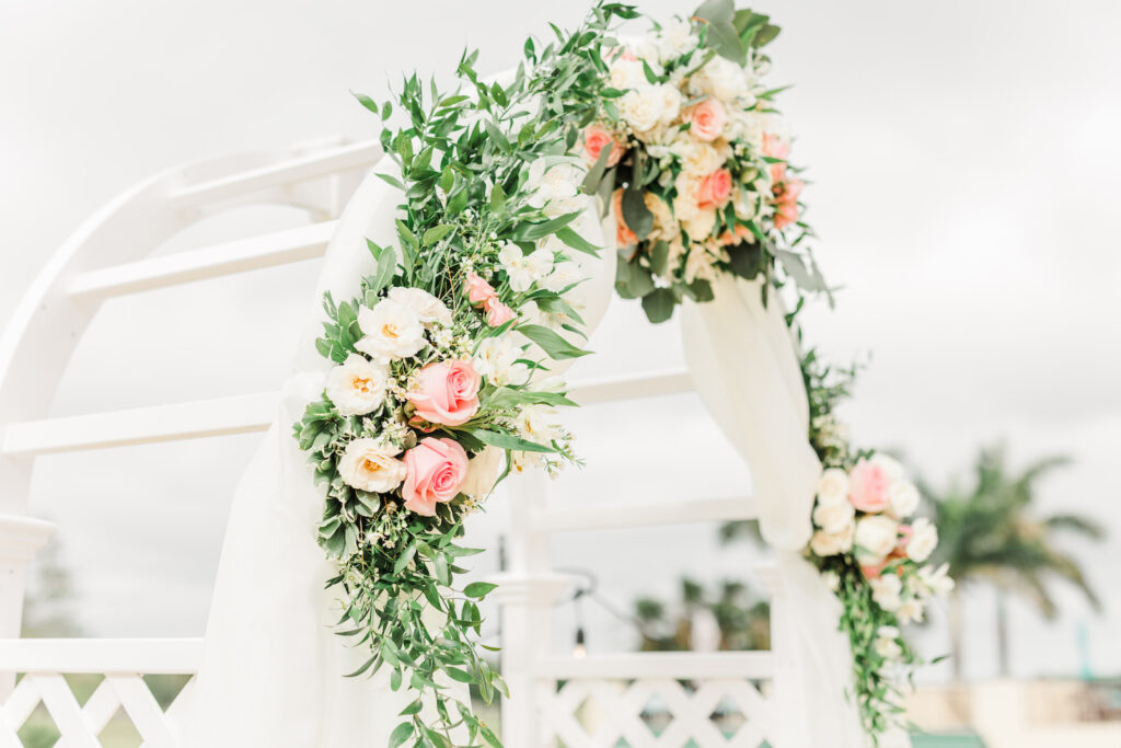 Romantic Pink St. Pete Garden Outdoor Wedding Ceremony Decor | Round Arch with White Linen Draping, Floral and Greenery Arrangement, White and Blush Pink Roses | Tampa Bay Wedding Florist Brides N Blooms Designs