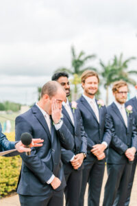 Romantic Pink St. Pete Garden Wedding Ceremony | Groom Emotional Reaction to Watching Bride Walking Down the Wedding Aisle
