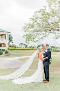 Romantic Pink Outdoor Garden St. Pete Wedding | Bride Wearing Full Length Veil with Groom | Wedding Venue Feather Sound Country Club