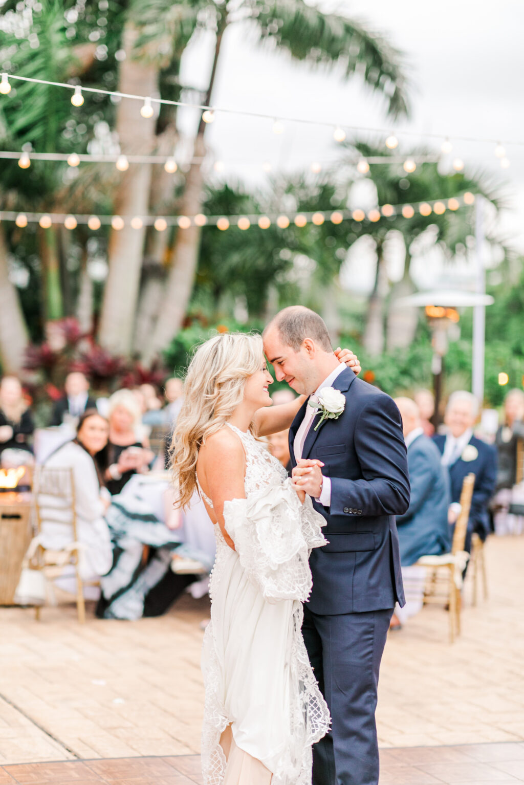 Romantic Pink Outdoor Garden St. Pete Wedding | Bride and Groom First Dance Under String Lights | Tampa Bay Wedding DJ Grant Hemond & Associates