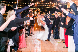 Romantic Pink Outdoor Garden St. Pete Wedding | Bride and Groom Dip Kiss During Sparkler Exit