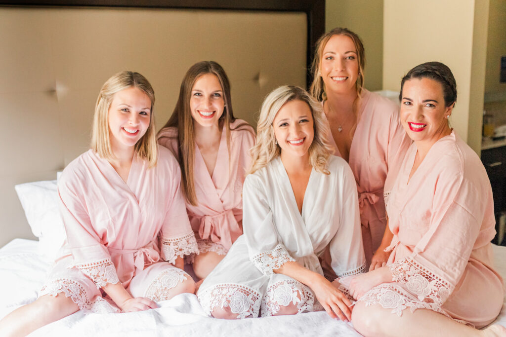 Bride and Bridesmaids Getting Ready Portrait in Matching Pale Pink Robes