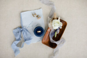Romantic Coastal Chic Blue Groom Wedding Accessories, His Wedding Vows Book, Monogram Cuff Links, Wedding Ring in Round Navy Blue Velvet Ring Box, Wooden Tray with White Rose, Babys Breathe, White Leaf and Bunnies Tail Floral Boutonniere | Tampa Bay Wedding Photographer Lifelong Photography Studio