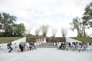 Rustic Outdoor Wedding Ceremony with White Chairs and a Wooden Backdrop | Tampa Florida Wedding Ceremony