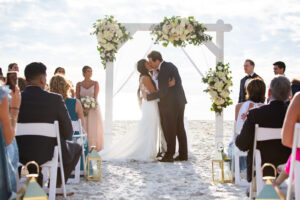 Bride and Groom First Kiss as Husband and Wife Wedding Portrait | Sarasota Beach Wedding at The Resort at Longboat Key Club