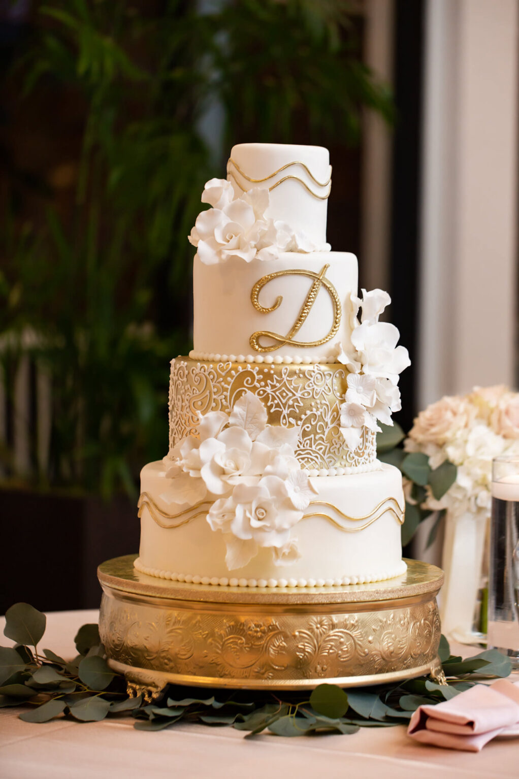 Four-Tiered White Wedding Cake with Sparkle and Floral Details