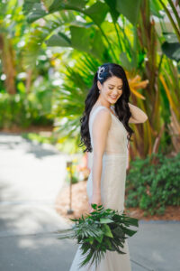 Florida Bride Holding Tropical Greenery Bouquet, Wearing Sheer Ines Di Santo Wedding Dress, Beach Inspired Hair with Long Waves
