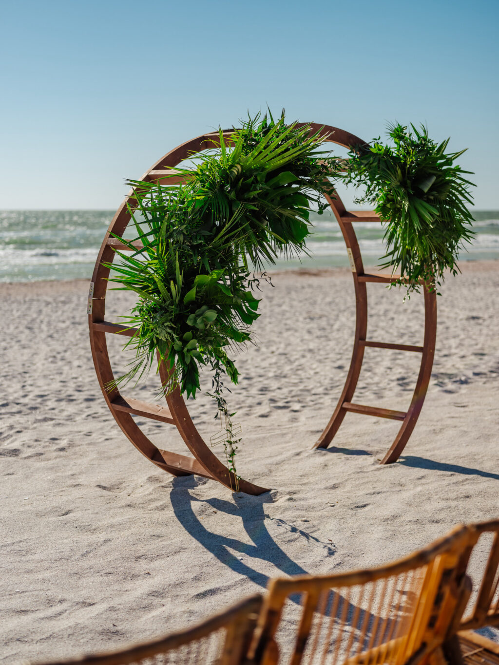 Tampa Bay Beachfront Ceremony, Wooden Circle Arch with Tropical Greenery Flora and Decor | Florida Beach Wedding Ceremony