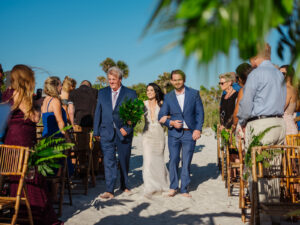 Florida Bride Walking Down the Aisle During Beachfront Wedding Ceremony at Pass-A-Grille Beach