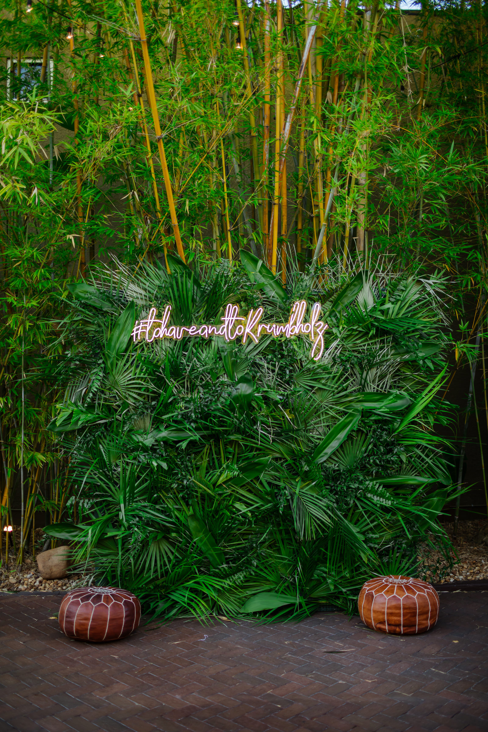 Tropical Inspired Florida Wedding Reception and Decor, Custom Photo Spot of Greenery and Palm Leaves with Custom Hashtag Neon Sign in Bamboo Courtyard | Unique Tampa Bay Wedding Venue NOVA 535 in Downtown St. Pete