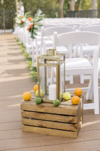 Tropical Pink and Green Wedding Ceremony Decor, Wooden Pallet with Orange, Limes, and Lemons, Gold Candle Lantern | Tampa Bay Wedding Planner Coastal Coordinating