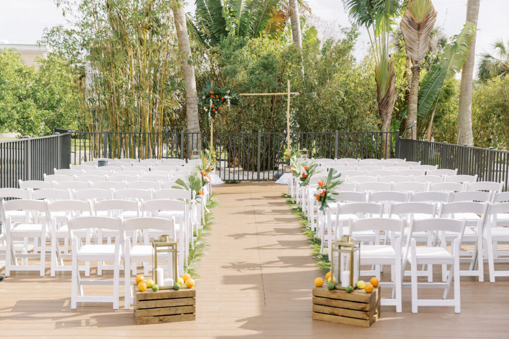 Tropical Pink and Green Wedding Ceremony Decor, Wooden Pallet with Orange, Limes, and Lemons, Gold Candle Lantern | Tampa Bay Wedding Planner Coastal Coordinating | Hotel Zamora
