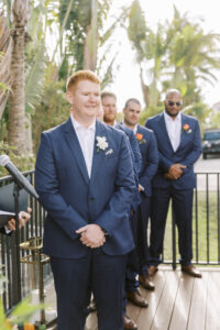 Tropical Pink and Green Wedding Ceremony, Groom Wearing Blue Suit Watching Bride Walking Down the Wedding Aisle