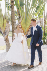Florida Classic Tropical Elegant Bride Wearing Off the Shoulder A Line Wedding Dress with Groom Wearing Blue Suit | Tampa Bay Wedding Hair and Makeup Savannah Olivia Beauty
