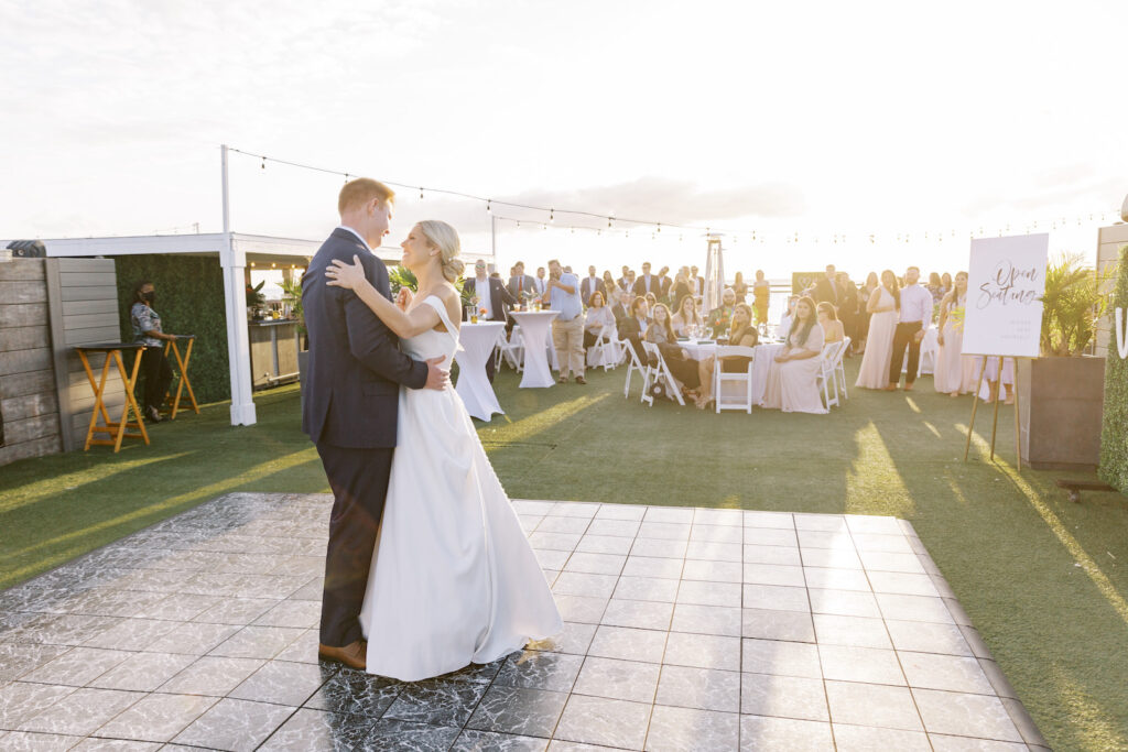 Sunset Tropical Pink and Green Wedding Reception | Bride and Groom First Dance | Tampa Bay Wedding DJ Graingertainment | Outdoor Rooftop St. Pete Waterfront Wedding Venue Hotel Zamora