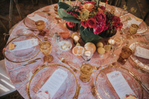 Moody Tablescapes with Clear Plating with Gold Trim and Pink and Orange Floral Centerpieces | Candle and Citrus Fruit Wedding Decor | MDP Events
