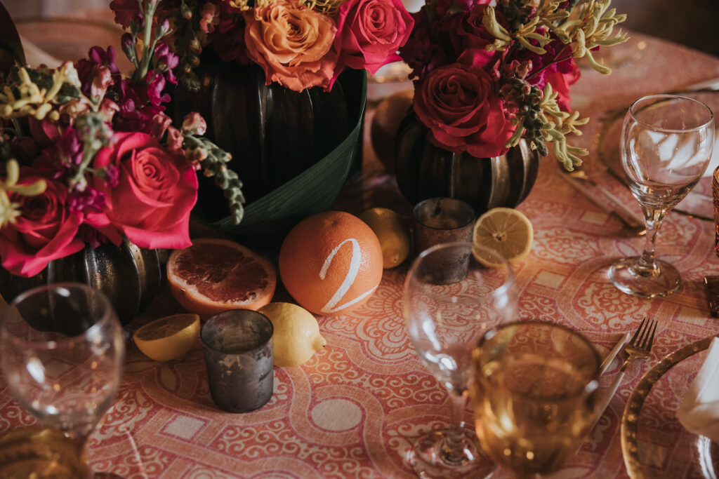 Fruit Wedding Table Numbers and Floral Centerpieces with Pink and Orange Florals | MDP Events