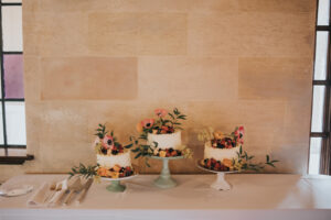 Single Tier Wedding Cakes with Orange, Pink and Greenery Floral Detail