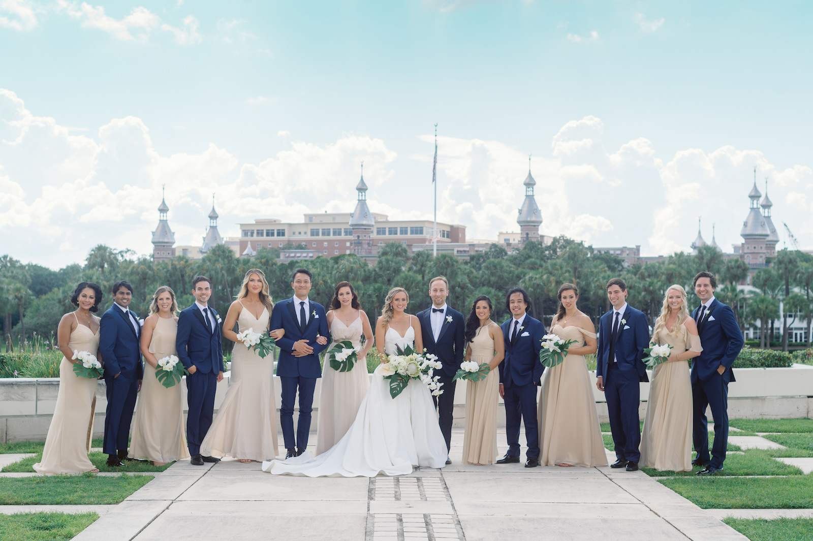 White and Green Modern Minimalist Tropical Wedding Party, Bride and Groom Kissing, Bridesmaids in Mix and Match Champagne Dresses, Groomsmen in Navy Blue Suits | Tampa Bay Wedding Hair and Makeup Femme Akoi Beauty Studio | The University of Tampa