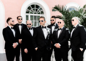 Classic Tampa Groom Wearing Black Tuxedo with Bowtie and Sunglasses with Groomsmen in Black Tuxedos and Sunglasses