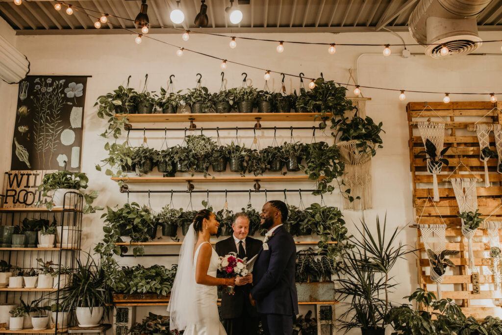 Intimate Elopement Wedding Ceremony, Bride and Groom Exchanging Wedding Vows at Unique Plant Shop Wedding Venue Wild Roots | Tampa Bay Wedding Planner Elope Tampa Bay