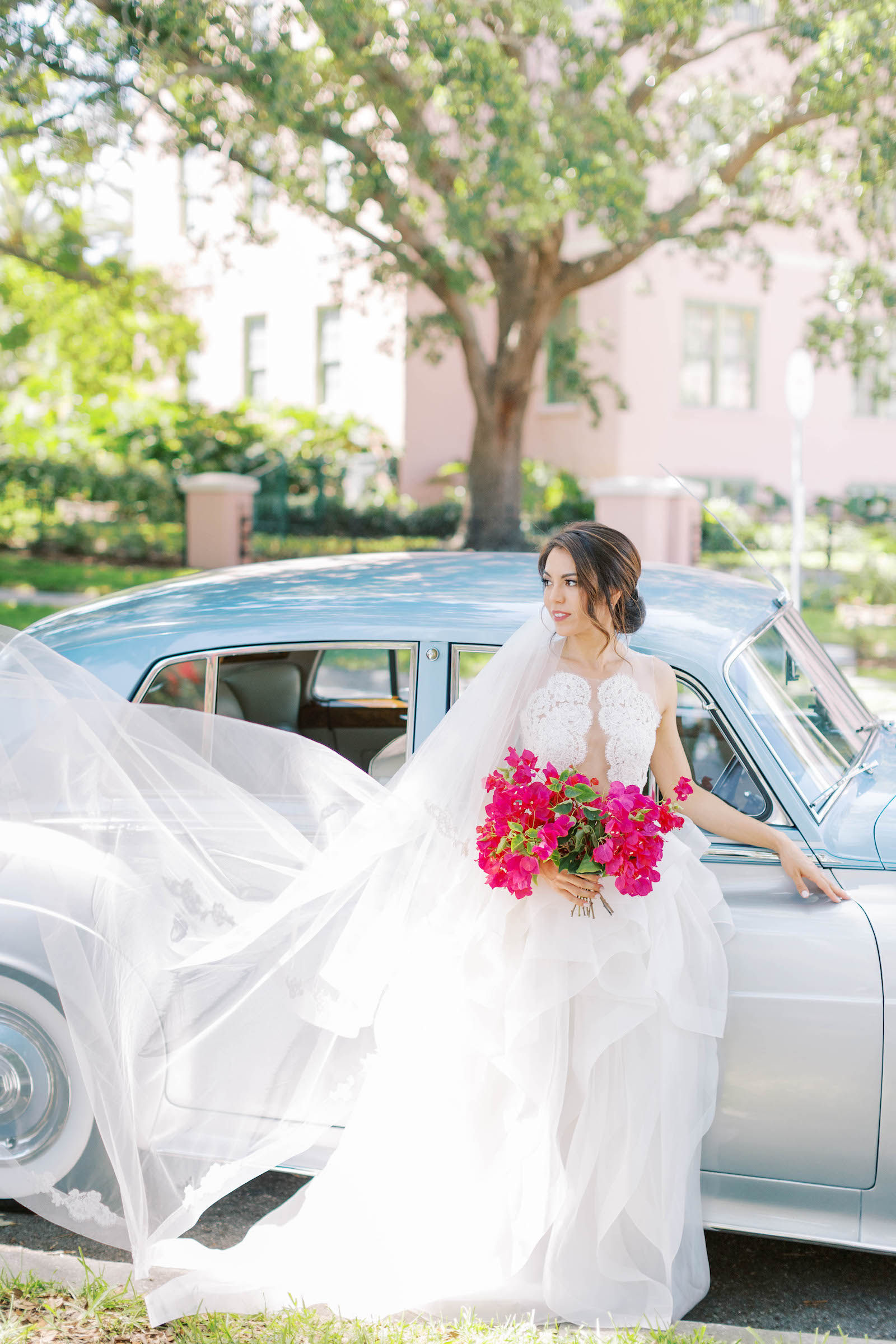 Bride in Front of a Vintage Car in Cutout Illusion Lace Ballgown with Ruffle Skirt and Hot Pink Floral Bouquet Wedding Portrait | St. Petersburg Wedding Venue Vinoy Renaissance