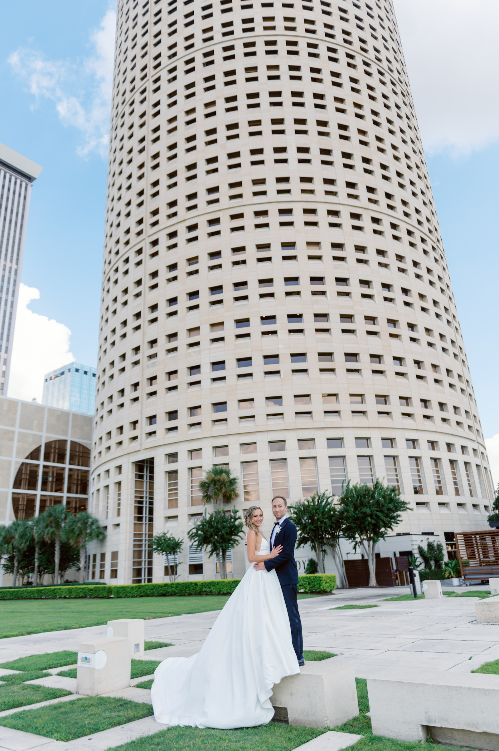 White and Green Modern Minimalist Tropical Wedding, Bride and Groom Outside Downtown Tampa Rivergate Tower | Downtown Tampa Wedding Portrait