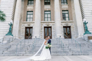 White and Green Modern Minimalist Tropical Wedding, Bride and Groom Outside Historic Downtown Courthouse Le Meridien | Tampa Bay Wedding Hair and Makeup Femme Akoi Beauty Studio
