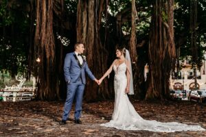 Bride and Groom Wearing Blue and Black Tuxedo Under Banyan Trees