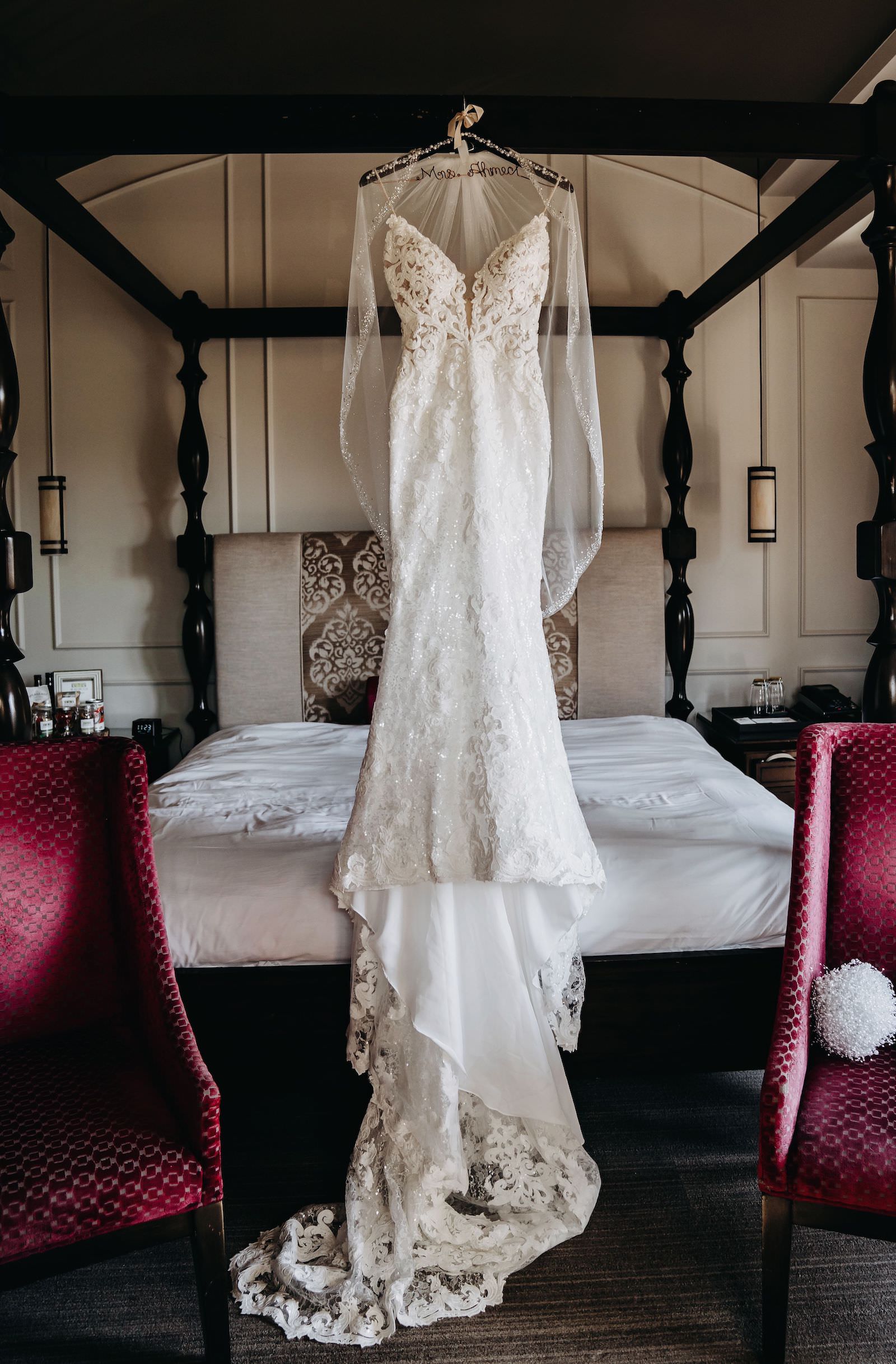 Lace and Illusion Fitted Wedding Dress with Veil Hanging on Bed