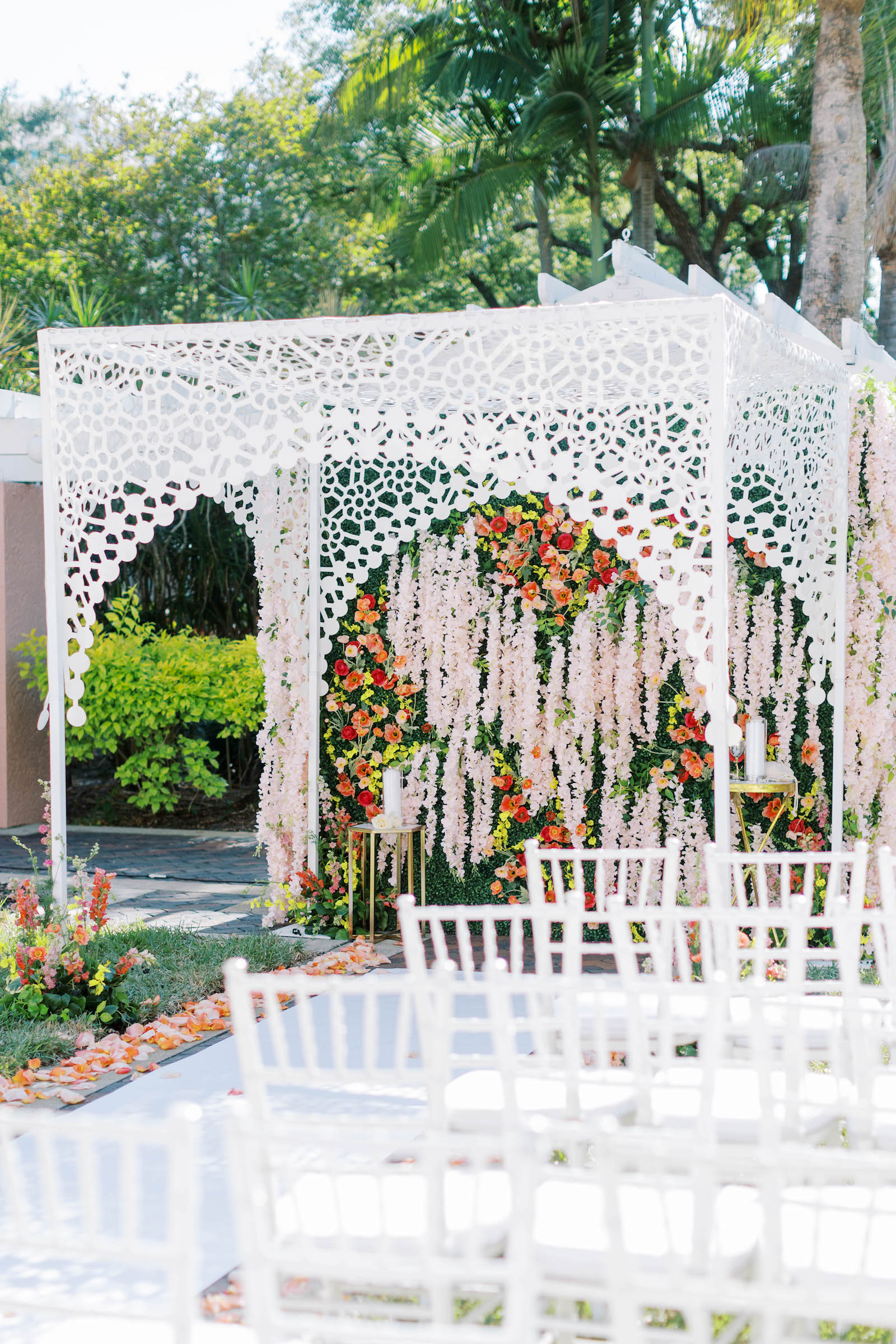 Luxurious Floral Ceremony Arch and Jewish Chuppah with Orange and Pink Draping Florals and Greenery | St. Pete Wedding Ceremony Venue Vinoy Renaissance | Planner Parties a la Carte