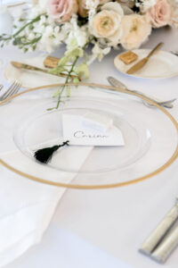 Classic Timeless Wedding Reception Decor, Clear Glass and Gold Rimmed Charger with White and Black Tassel Seating Card | Tampa Bay Wedding Stationery A&P Design Co | Wedding Rentals Kate Ryan Event Rentals | Wedding Planner Elegant Affairs by Design Co