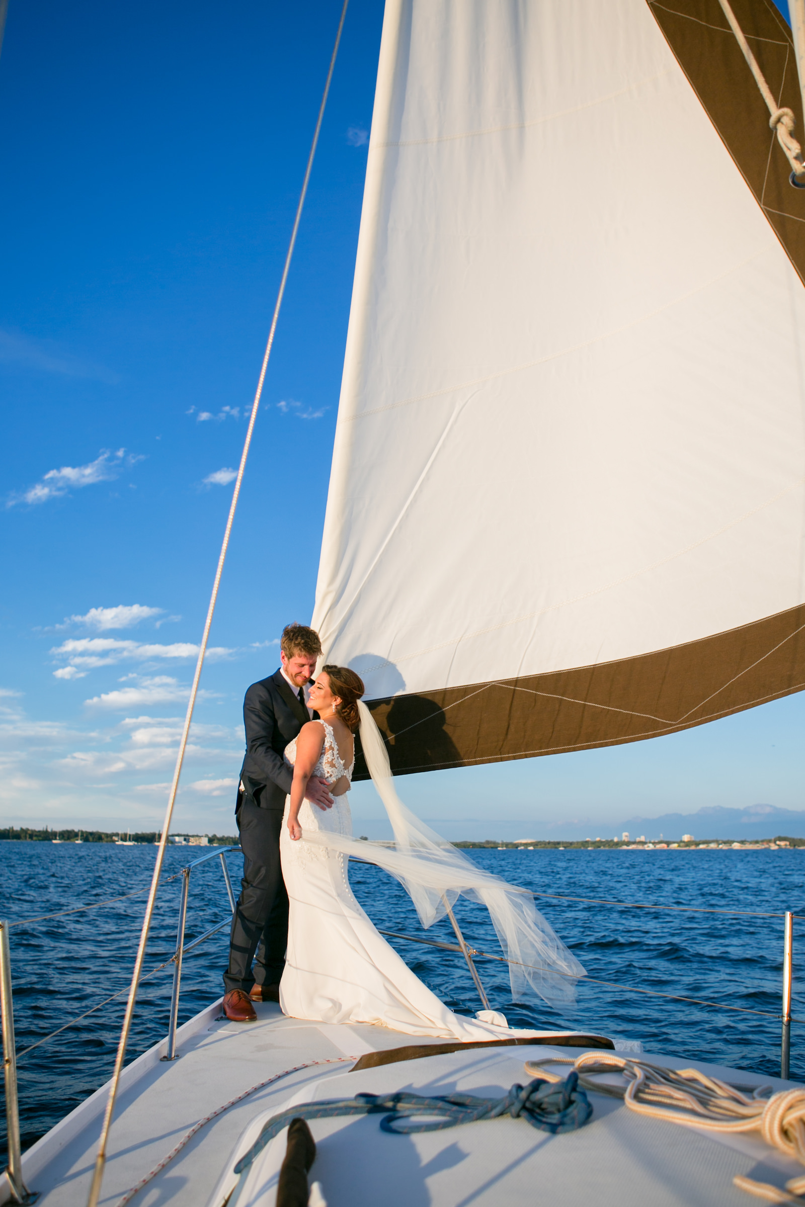 Florida Bride and Groom Sitting on Sail Boat Wedding Portrait | Tampa Bay Wedding Photographer Carrie Wildes Photography