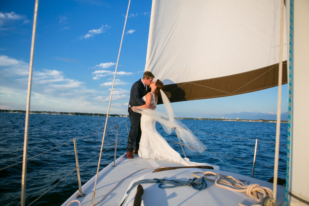 Florida Bride and Groom Sitting on Sail Boat Wedding Portrait | Tampa Bay Wedding Photographer Carrie Wildes Photography