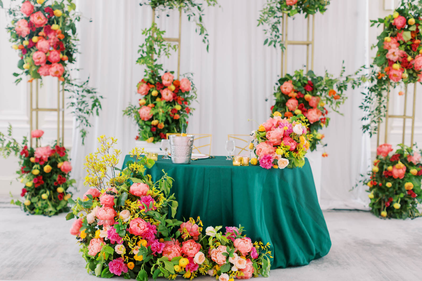 Greenery with Pink and Orange Floral Décor Pieces and Teal Green Sweetheart Table Reception Decor | St. Pete Wedding Planner Parties a la Carte