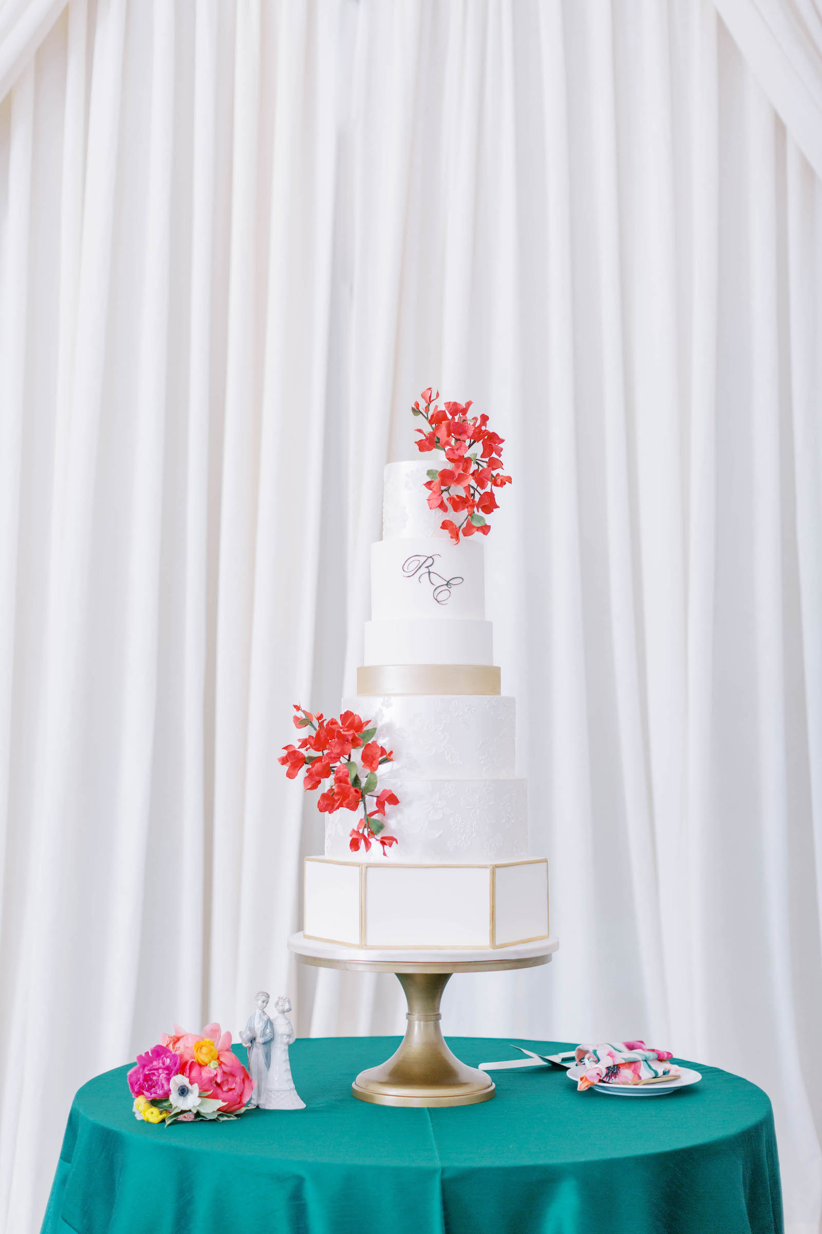 Six Tier White Wedding Cake with Gold Accent Details and Hot Pink Florals