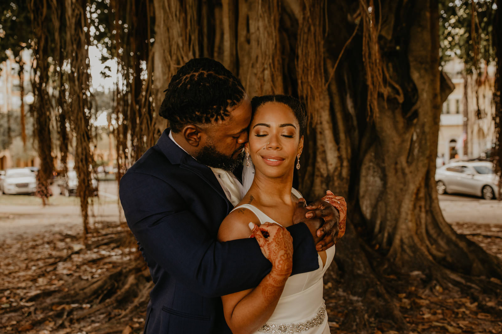 Intimate Elopement Wedding, Bride Wearing Fit and Flare Wedding Dress with Rhinestone Crystal Belt, Groom Wearing Navy Blue Suit and White Tie from Behind Under Banyan Trees, First Look Portrait