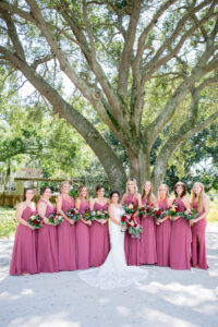 Dusty Rose and Mauve Wedding, Bride Holding Red and Blush Roses and Greenery Floral Bouquet Wearing Lace Wedding Dress, Bridesmaids Wearing Dusty Rose Mix and Match Dresses | Tampa Bay Wedding Photographer Carrie Wildes Photography | Wedding Florist Iza’s Flowers