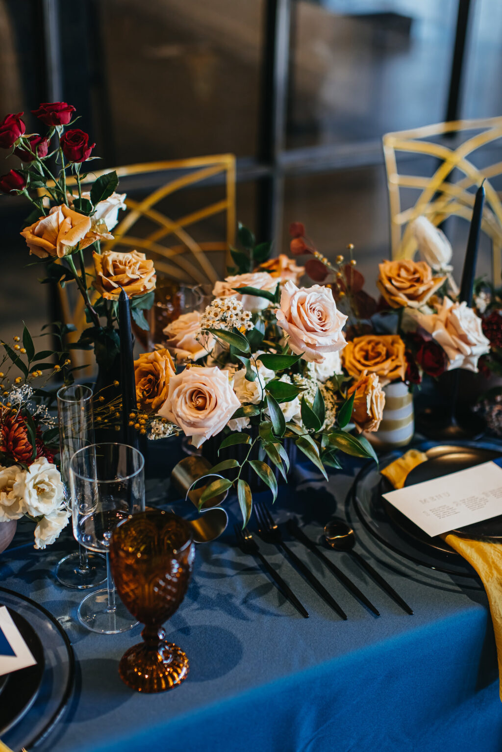 Modern and Edgy Fall Wedding Reception Decor, Royal Blue Table Linen, Vintage Water Goblets, Black Flatware, Blush Pink and Yellow Roses Flower Low Centerpieces | Tampa Bay Wedding Rentals Kate Ryan Event Rentals