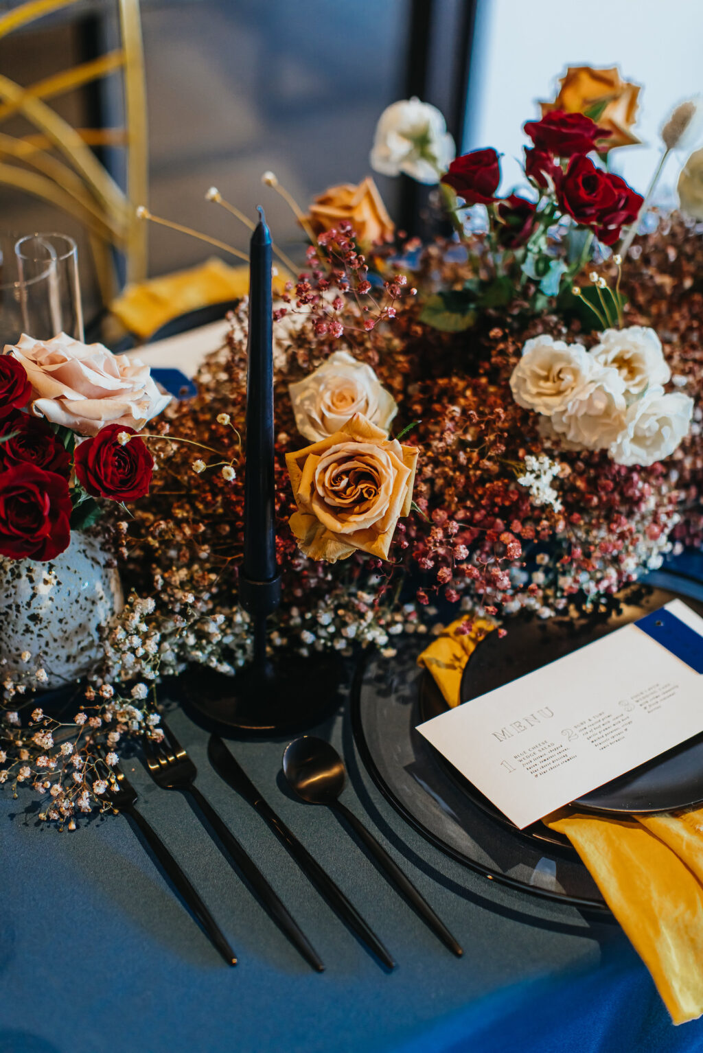 Modern and Edgy Fall Wedding Reception Decor, Royal Blue Table Linen, Vintage Water Goblets, Black Flatware, Blush Pink, Red and Yellow Roses, Pink and White Babys Breathe Flower Low Centerpieces, Clear Glass Chargers, Yellow Linen Napkin, Blue Candlestick | Tampa Bay Wedding Rentals Kate Ryan Event Rentals