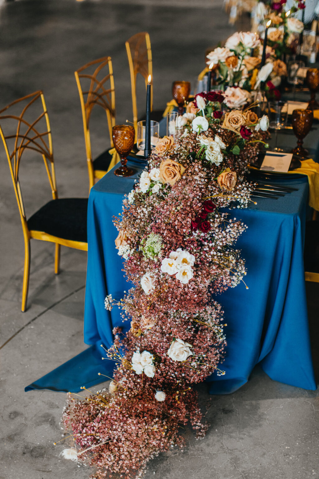 Modern and Edgy Fall Wedding Decor, Long Table with Royal Blue Table Linen, Lush Floral Table Runner with White and Yellow Roses, Pink and White Babys Breathe, Chic Gold Chairs | Tampa Bay Wedding Venue Hyde House | Wedding Rentals Kate Ryan Event Rentals