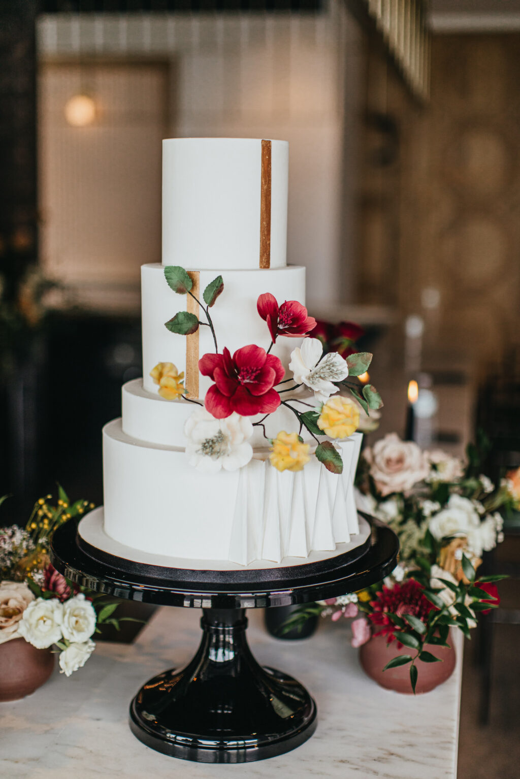 Modern and Edgy Fall Wedding Reception Decor, Three Tier White Textured Wedding Cake with Real Red and Yellow Flowers, White and Gold Bar Decorated with Lush Floral Arrangements, Greenery, Yellow, Blush Pink and Burgundy Read Roses, Babys Breathe | South Tampa Wedding Venue Hyde House