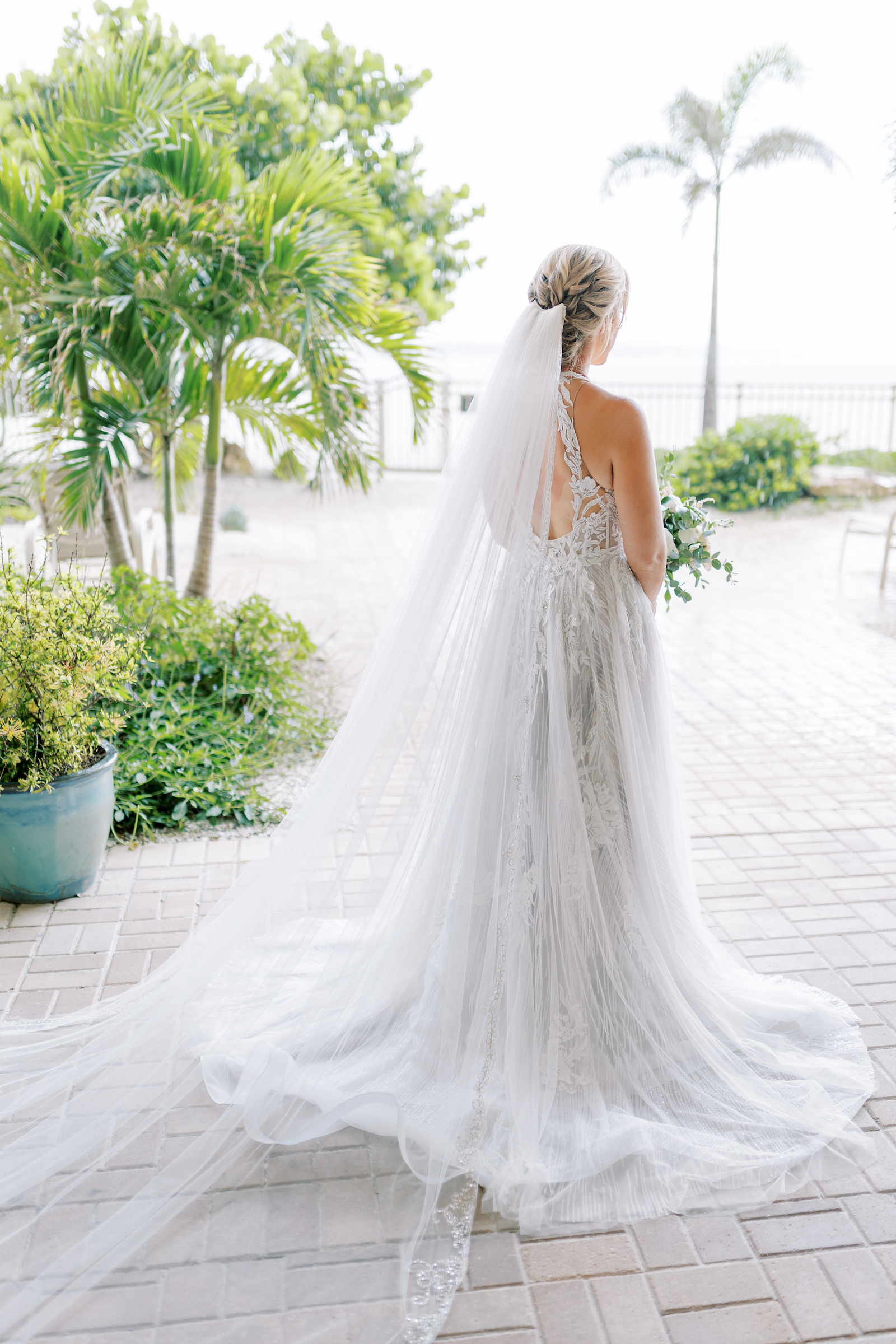 Bride in Long Train Illusion Back Wedding Gown and Long Veil