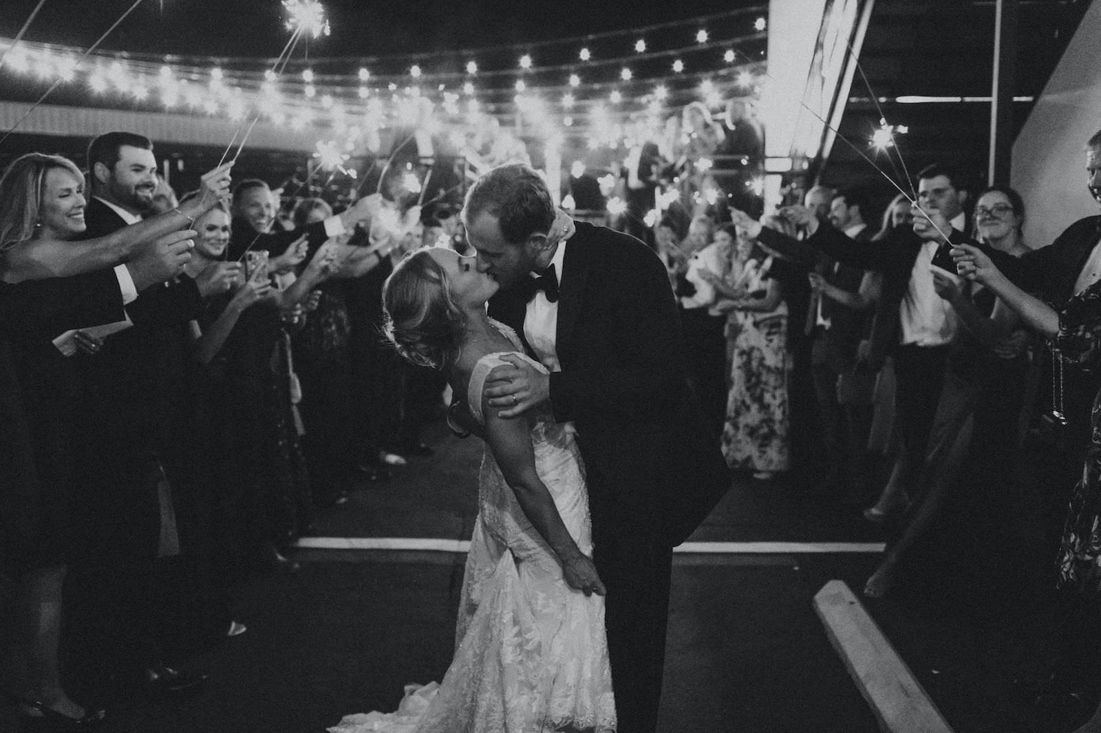 Bride and Groom Kissing During Sparkler Exit Wedding Portrait
