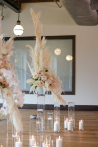 Modern and Timeless Black and White Wedding Ceremony Decor, Black Chairs, White and Blush Pink Roses Flowers and Pampas Grass Arrangements on Tall Clear Glass Vases, Hurricane Vases with Candles in Aisle | Tampa Bay Wedding Photographer Lifelong Photography Studio | Wedding Venue Oxford Exchange